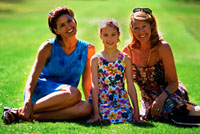 Picture of two women and a teenage girl sitting on a picnic blanket